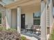 Inviting covered front porch featuring a seating area, perfect for enjoying the outdoors at 11807 Midnight Way, Huntersville, NC 28078