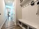 Hallway featuring wood floors, a bench with coat hooks, and a view of the living area at 11807 Midnight Way, Huntersville, NC 28078