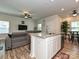 Open-concept kitchen featuring a granite island and seamless flow into the living area at 11807 Midnight Way, Huntersville, NC 28078