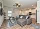 Open-concept living room with hardwood floors seamlessly connecting to the modern kitchen at 11807 Midnight Way, Huntersville, NC 28078