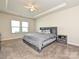 Spacious main bedroom featuring a decorative trey ceiling, large windows, and carpeted floors at 11807 Midnight Way, Huntersville, NC 28078