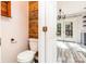 View into stylish half bathroom, with rustic wood accents and access to the kitchen at 12250 Wallace Ridge Dr, Charlotte, NC 28269