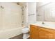 Clean bathroom with a shower-tub combo, wooden vanity, and tile flooring at 12250 Wallace Ridge Dr, Charlotte, NC 28269