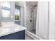 Bathroom with an updated shower with marble-look tiling and modern vanity at 12250 Wallace Ridge Dr, Charlotte, NC 28269