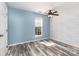 Cozy bedroom featuring a ceiling fan, window, and wood-look flooring at 12250 Wallace Ridge Dr, Charlotte, NC 28269