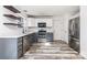 Well-lit kitchen with stainless steel appliances, floating shelves, and white and gray cabinets at 12250 Wallace Ridge Dr, Charlotte, NC 28269