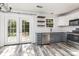 Updated kitchen with stainless steel appliances, quartz countertops, and French doors leading to the backyard at 12250 Wallace Ridge Dr, Charlotte, NC 28269