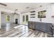 Bright kitchen open to living room, featuring floating shelves and stainless steel appliances at 12250 Wallace Ridge Dr, Charlotte, NC 28269