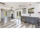 Bright kitchen open to living room, featuring floating shelves and stainless steel appliances at 12250 Wallace Ridge Dr, Charlotte, NC 28269