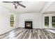 Open living room boasting new floors, a fireplace, and natural light through large windows and glass doors at 12250 Wallace Ridge Dr, Charlotte, NC 28269