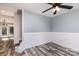 Inviting living area with wainscoting, ceiling fan, and staircase at 12250 Wallace Ridge Dr, Charlotte, NC 28269
