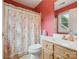 Cozy bathroom featuring a patterned shower curtain, and vanity with sink, and bright red walls at 13101 Kensworth Ct, Charlotte, NC 28277
