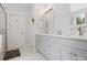 Bathroom featuring double sink vanity with storage cabinets and a glass-enclosed shower at 13101 Kensworth Ct, Charlotte, NC 28277