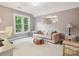 Comfortable bedroom with a relaxing atmosphere, light color palette, and a window view at 13101 Kensworth Ct, Charlotte, NC 28277