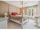 Comfortable bedroom with a four-poster bed, a ceiling fan, and lots of natural light at 13101 Kensworth Ct, Charlotte, NC 28277