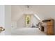 Spacious bedroom features vaulted ceilings, a ceiling fan, and a sunlit window with exercise equipment at 13101 Kensworth Ct, Charlotte, NC 28277