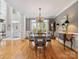 Elegant dining room featuring a glass table, chandelier, and large windows at 13101 Kensworth Ct, Charlotte, NC 28277