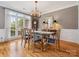 Elegant dining room featuring a glass table, chandelier, and large windows at 13101 Kensworth Ct, Charlotte, NC 28277