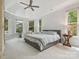 Serene main bedroom with large windows, tray ceiling, and a seating area at 13101 Kensworth Ct, Charlotte, NC 28277