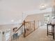 Bright staircase with carpet runner that overlooks a fireplace and sitting area at 13101 Kensworth Ct, Charlotte, NC 28277