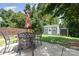 Backyard patio with outdoor dining furniture under a shade tree with detached storage and a fenced boundary at 13510 Brandon Trail Dr, Charlotte, NC 28213