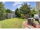 Spacious backyard, complete with patio seating, shed, lush lawn, and a mature tree for shade at 13510 Brandon Trail Dr, Charlotte, NC 28213
