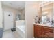 Bathroom features a soaker tub and a vanity with plenty of counter space and great light fixtures at 13510 Brandon Trail Dr, Charlotte, NC 28213