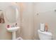 Cozy half-bathroom with a pedestal sink, neutral decor and fixtures at 13510 Brandon Trail Dr, Charlotte, NC 28213