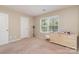 Neutral bedroom featuring a window for lots of natural light and a painted dresser at 13510 Brandon Trail Dr, Charlotte, NC 28213
