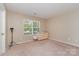 Neutral bedroom featuring a window for lots of natural light and a painted dresser at 13510 Brandon Trail Dr, Charlotte, NC 28213