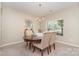Elegant dining area featuring a round table, chandelier, and carpet flooring at 13510 Brandon Trail Dr, Charlotte, NC 28213