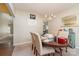 Elegant dining area featuring a round table, chandelier, and carpet flooring at 13510 Brandon Trail Dr, Charlotte, NC 28213