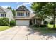 Charming two-story home with a two-car garage, brick accents, and well-manicured landscaping at 13510 Brandon Trail Dr, Charlotte, NC 28213
