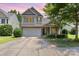 Charming two-story home with a two-car garage, brick accents, and well-manicured landscaping at 13510 Brandon Trail Dr, Charlotte, NC 28213
