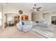Bright living room featuring a large sectional sofa and open access to the dining and kitchen areas at 13510 Brandon Trail Dr, Charlotte, NC 28213