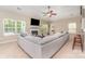 Bright living room with a fireplace, large sectional sofa, and views of the landscaped yard at 13510 Brandon Trail Dr, Charlotte, NC 28213