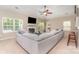 Bright living room with a fireplace, large sectional sofa, and views of the landscaped yard at 13510 Brandon Trail Dr, Charlotte, NC 28213