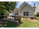 Relax on the patio with comfortable seating, dining area, and lush backyard views perfect for entertaining outdoors at 13510 Brandon Trail Dr, Charlotte, NC 28213