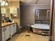 Bathroom with double sink vanity, modern backsplash and stand alone bathtub with accent wall at 1355 Oak Breeze Dr, Mooresville, NC 28115