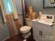 Bathroom featuring a toilet, vanity, and decorated walls at 1355 Oak Breeze Dr, Mooresville, NC 28115