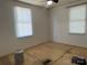 Empty bedroom featuring two windows and flooring that needs replacement at 1355 Oak Breeze Dr, Mooresville, NC 28115