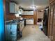 Kitchen with white cabinets, black appliances, wood-look paneling, tile floors, and pantry at 1355 Oak Breeze Dr, Mooresville, NC 28115