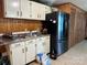 Kitchen featuring white cabinets, dark countertops, tile floors and modern stainless steel refrigerator at 1355 Oak Breeze Dr, Mooresville, NC 28115