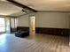 Empty living room with wood-look floors, a ceiling fan and natural light from the patio doors at 1355 Oak Breeze Dr, Mooresville, NC 28115