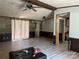 Spacious, empty living room with wood-look floors, a ceiling fan and paneled walls at 1355 Oak Breeze Dr, Mooresville, NC 28115
