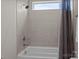 Modern bathroom featuring tiled walls, a shower head, and a bathtub with a gray shower curtain at 152 Riverstone Dr, Davidson, NC 28036