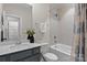 Bathroom featuring a shower-tub combo with a white tiled wall, and a gray vanity with white countertop at 152 Riverstone Dr, Davidson, NC 28036