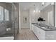 Bright bathroom features a granite countertop, undermount sinks, and a glass enclosed shower with seat at 152 Riverstone Dr, Davidson, NC 28036