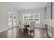 This dining room has a chandelier, hardwood floors, large windows and a view to the back porch at 152 Riverstone Dr, Davidson, NC 28036