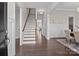 Elegant foyer with hardwood floors, staircase, and decorative wainscoting at 152 Riverstone Dr, Davidson, NC 28036
